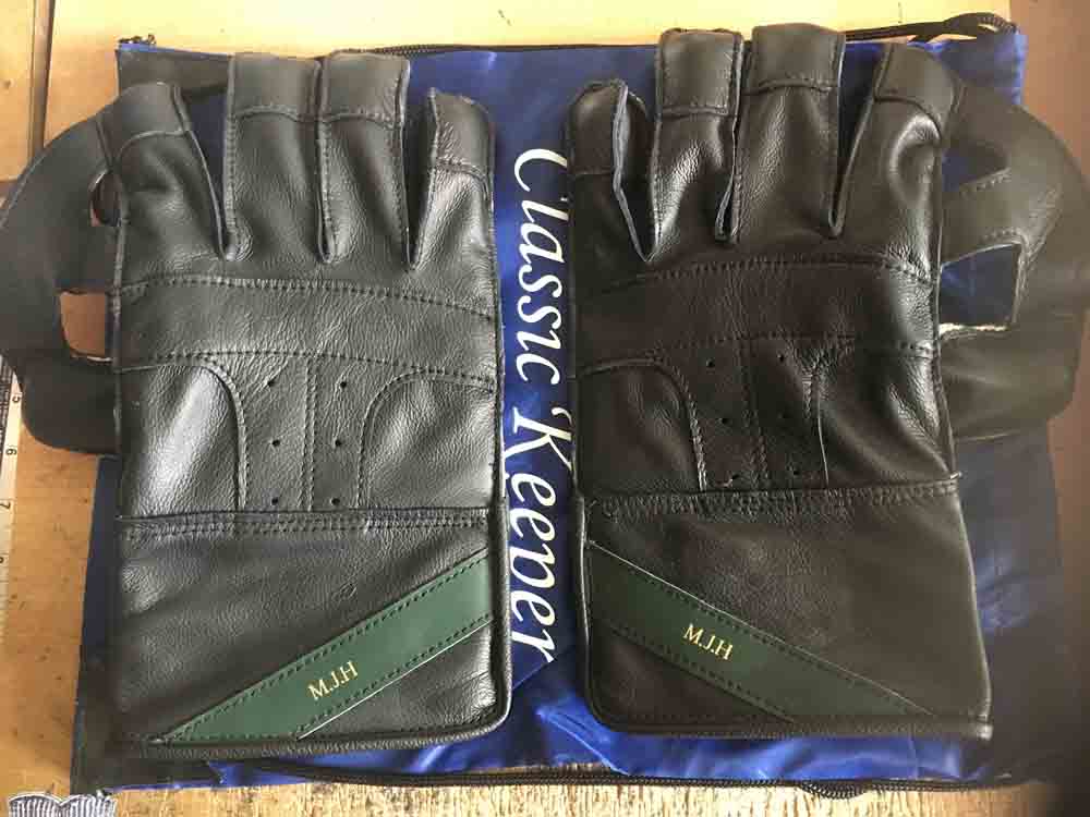 Black gloves with green name tag