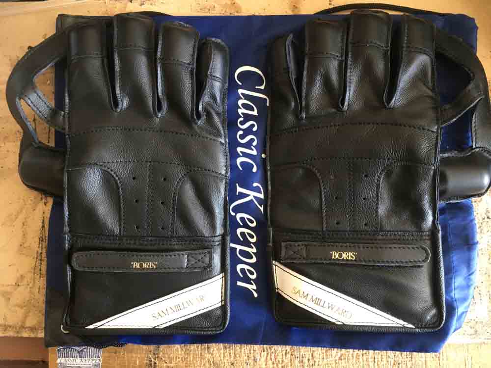 Black wicket keeping gloves with name tags