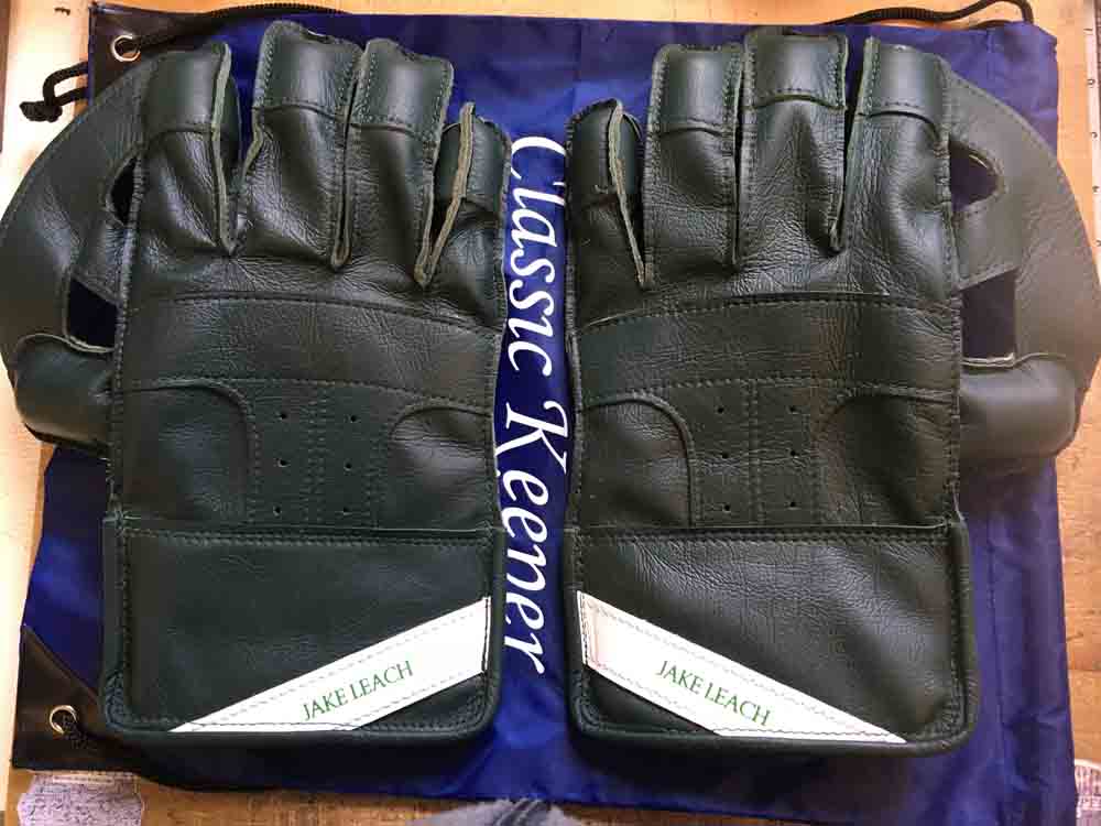 Black wicket keeping gloves with white name tags