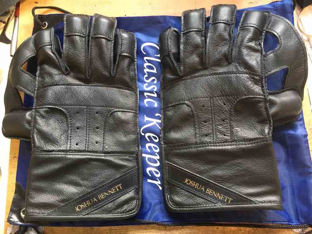 All black wicket keeping gloves with name tags